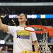 Michigan freshman Mitch McGary smiles as he revs up the crowd before cutting a piece of the net after Michigan beat Florida to win the NCAA South Regional Championship and advance to the Final Four at Cowboys Stadium on Sunday, March 31, 2013. Melanie Maxwell I AnnArbor.com